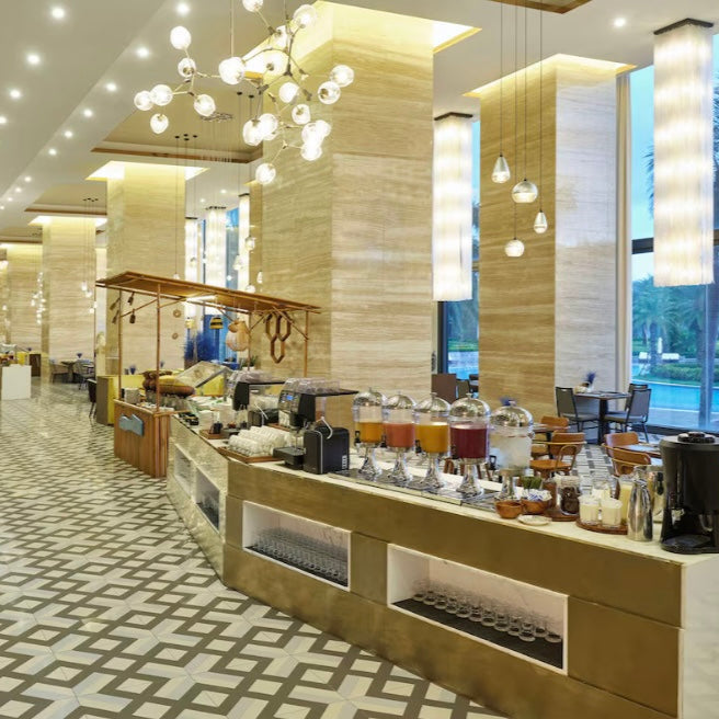 Modern hotel lobby with a coffee bar and seating area